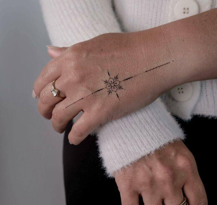 Fine-line hand tattoo 1