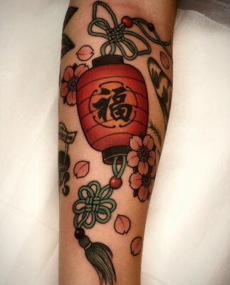 Colorful half-sleeve tattoo of Vietnamese lanterns in orange and green
