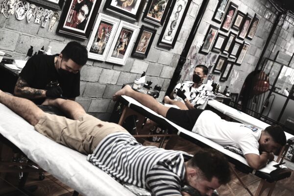 Tattoo artists working at The Hangout Tattoo Studio, Hoi An, Vietnam