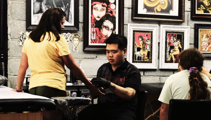 The Hangout Tattoo artist, Mickey, preparing a customer for their tattoo