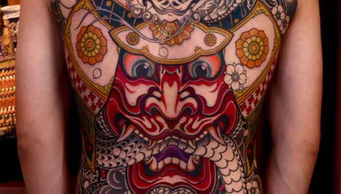 Colourful back tattoo of a mythological design